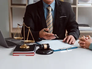Criminal defense lawyer reviewing paperwork and explaining options to seal a client’s Florida criminal record.