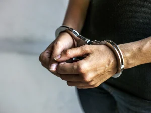 Close-up of hands in handcuffs, symbolizing sentencing and criminal justice
