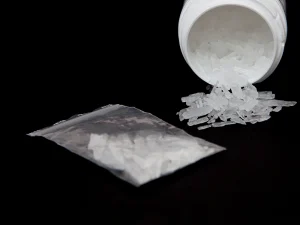 Plastic bag and spilled container of crystal meth on black background representing evidence in a Florida drug crime appeals case