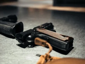 Gun on table symbolizing police seizure of firearm in Tampa garage after consent search resulting in felon case