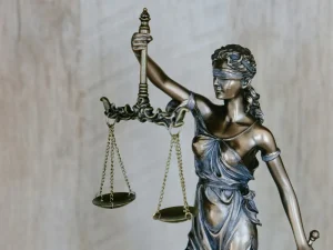 Bronze blindfolded Lady Justice statue holding scales symbolizing Florida rape shield law protections