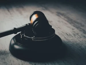 Judge gavel on wooden desk in low light symbolizing court ruling on involuntary commitment for violent predators