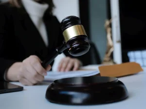 Judge with gavel at desk near files, depicting decision on warrantless GPS searches and seizures in Tampa case