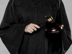 Judge in black robe holding gavel and block, symbolizing Florida criminal motion for judicial disqualification