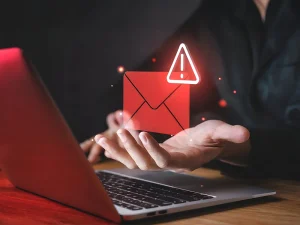 Red email alert icon hovering over a laptop, symbolizing restitution in Florida white-collar crime cases