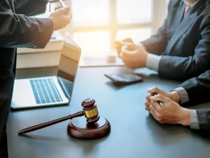 Criminal defense attorneys discussing a case at a conference table with a judge’s gavel in the foreground, symbolizing violent crime sentencing under the ACCA in Florida